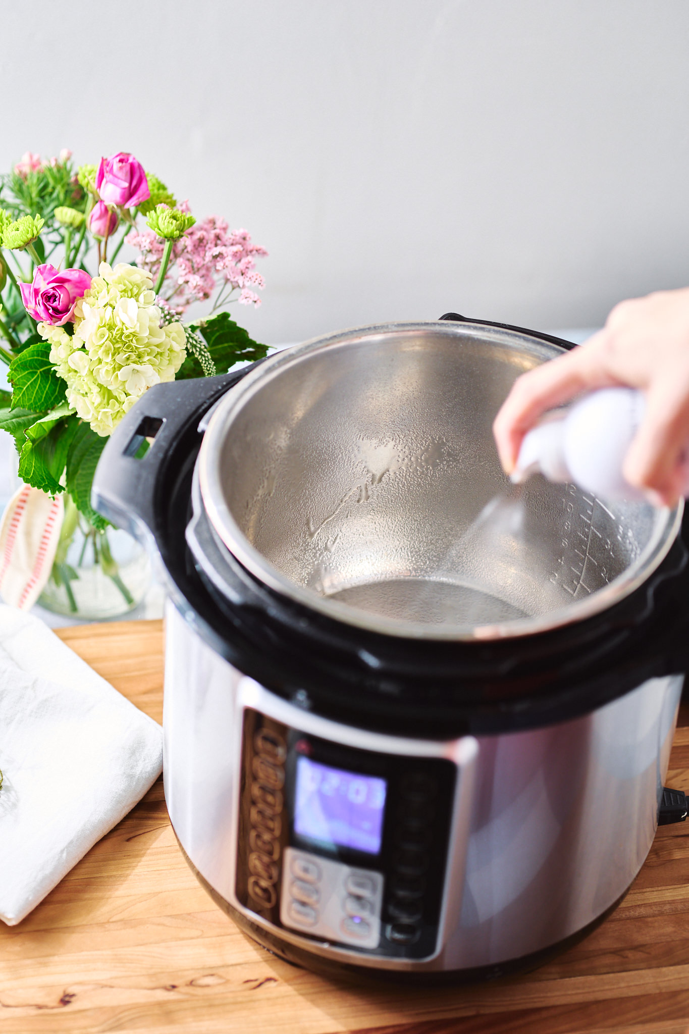 Spraying Instant Pot with oil